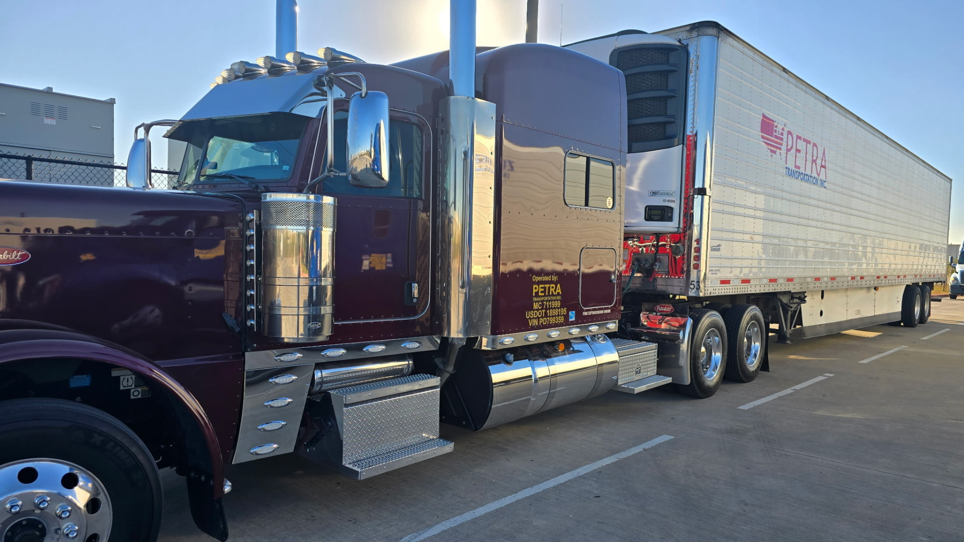 Chrome semi truck coupled to a white reefer trailer