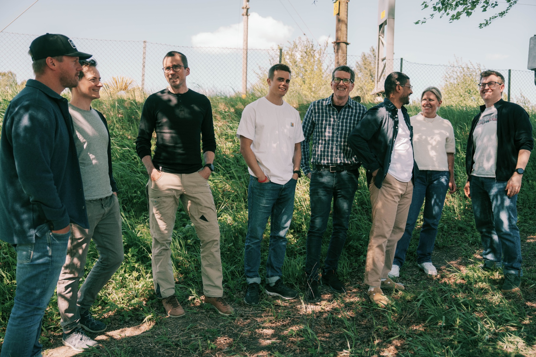 The Surfact team standing together in a sunlit Norwegian meadow