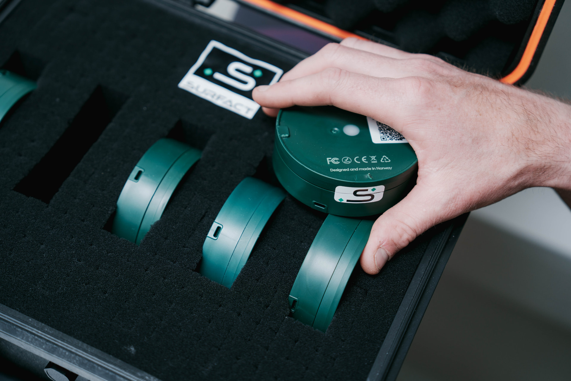 The Emma Smart Tracker held beside a medical case
